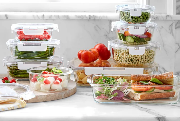 several transparent glass pantry storage containers on the table