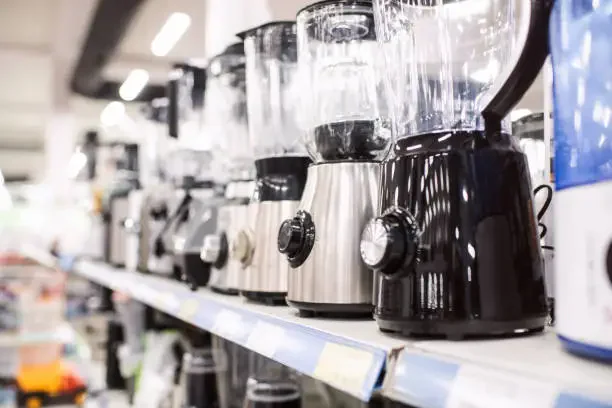 electric mixers and blenders on a shelf in a store or showroom